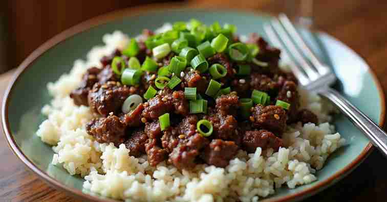 plate of Mongolian Ground Beef served over a bed of white steamed rice